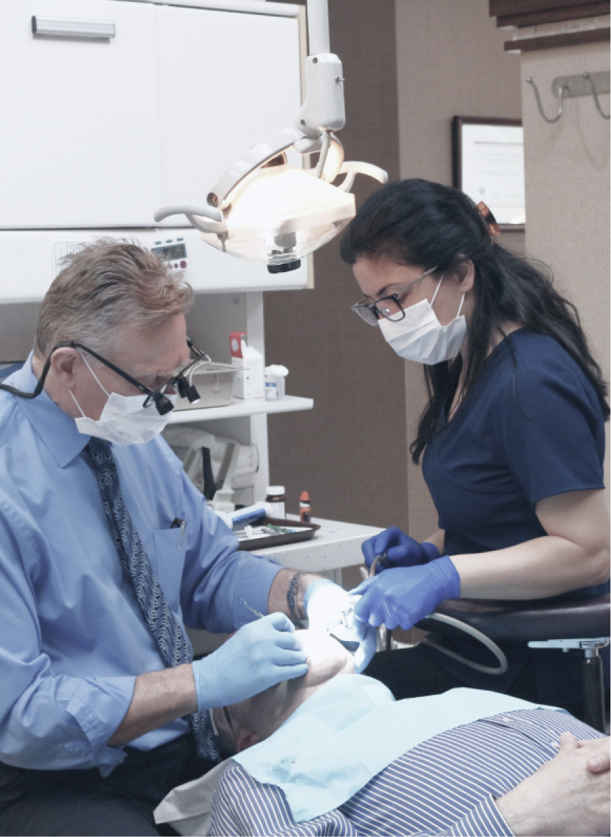 Burnaby holistic dentist Dr. Peter Balogh providing dental care to a patient at VCCID