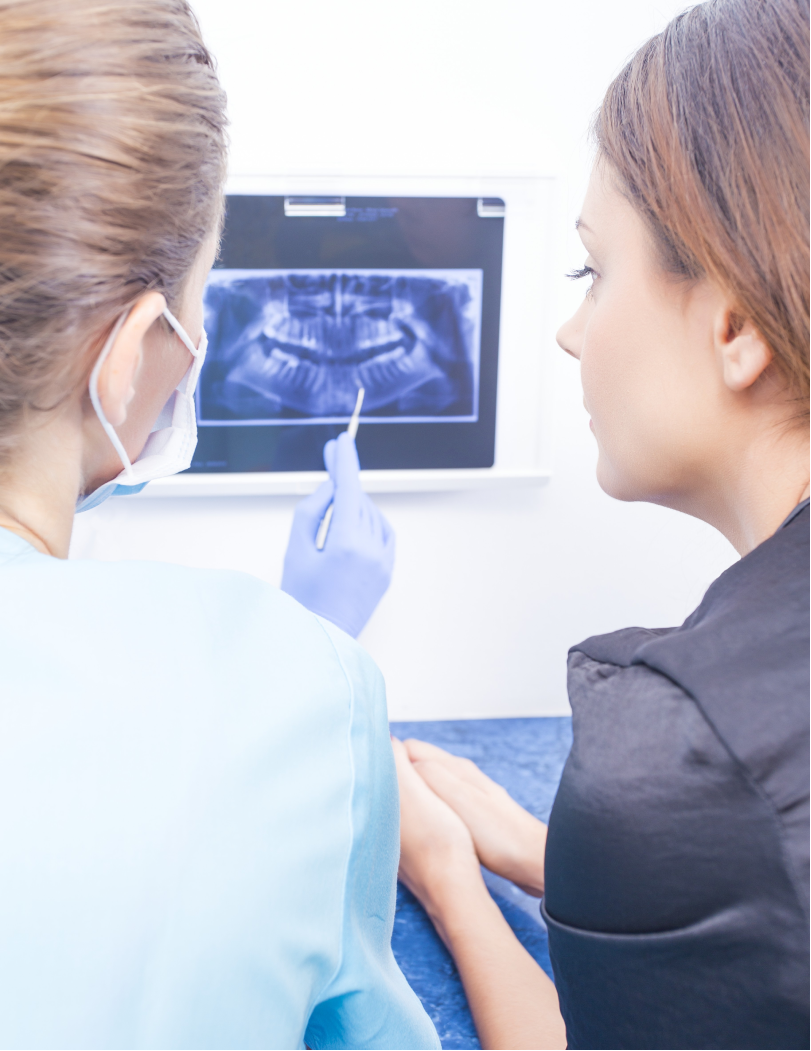 A patient and dentist reviewing the digital results from a CBCT scan